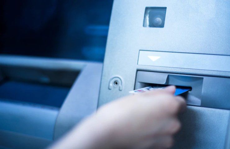 Una persona utilizza una carta ad uno sportello ATM