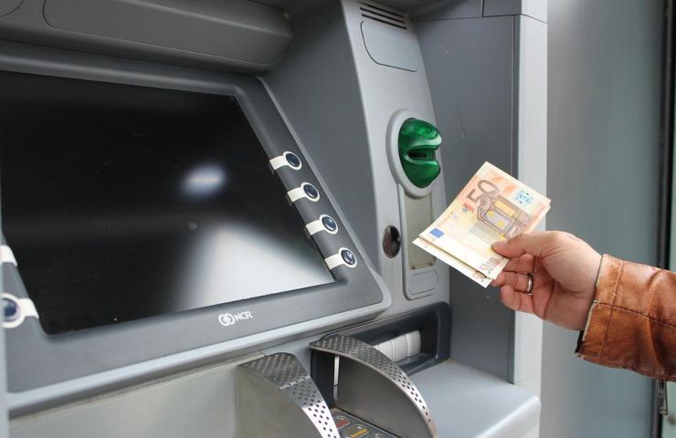Una persona preleva dei soldi allo sportello ATM